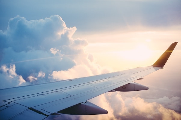 Airplane wing in the sky with sunlight